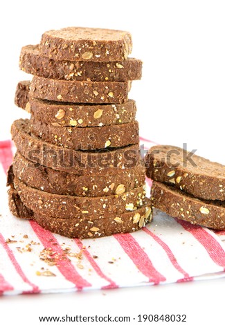Slices of rustic multigrain bread in vertical format on white background