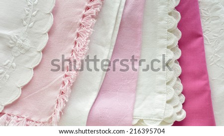 Pretty assortment of pink and white napkins and fabric in horizontal format