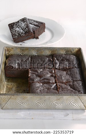 Extremely rich fudge chocolate brownies made without any grains, totally gluten free, in vertical format with copy space