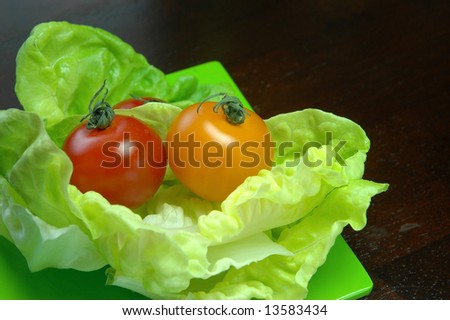 Fresh sweet cherry tomatoes on butter lettuce