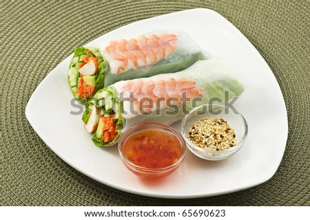 Fresh healthy prawn and salad sushi roll with sweet chili dipping sauce and sesame seeds