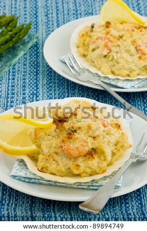 Coquilles St. Jacques seafood in scallop shells with asparagus in vertical format