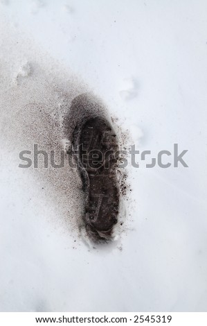 footprint in snow with ash to symbolize the saying \