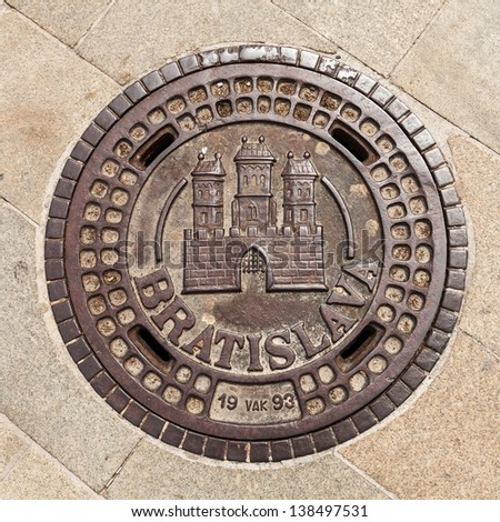 Manhole on Main Square in Bratislava, Slovakia, showing the coat of arms of the city
