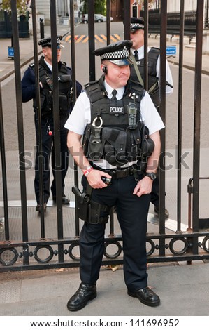 LONDON, UK - SEP 12: Security officers in front of PM\'s residence at Downing Street 10 on September 12, 2010. After the murder of UK citizen in May 2013, security was tightened in the city.