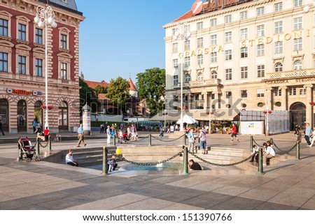 ZAGREB, CROATIA - JUN 2: People walking around Mandusevac Fountain on main city square on June 2, 2012 in Zagreb, Croatia. Ancient fountain was buried in 1898 and revealed and reconstructed in 1986.