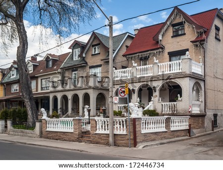 TORONTO, CANADA - MAY 2, 2007: Houses on College Street West, a district in Toronto, Ontario, also known as Little Italy, renowned for its numerous Italian Canadian restaurants and businesses.