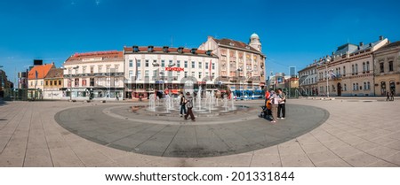 OSIJEK, CROATIA - MAY 9, 2009: People gathering around fountain on main square of Osijek. Osijek is the largest city in Slavonia, fourth largest city in Croatia and seat of the Osijek-Baranya county.