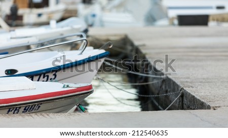 VELI IZ, CROATIA - AUGUST 15, 2014: Fishermen\'s boats parked and tied in city harbour in Veli Iz, on island Iz. Veli Iz is largest settlement on the island Iz.