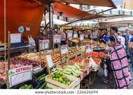 PALERMO, ITALY - OCTOBER 23, 2014: Customers and sellers on Ballaro farmer's market on the streets of old Palermo city center, around Plaza Carmine. It is the oldest of Palermo's Arabic markets.