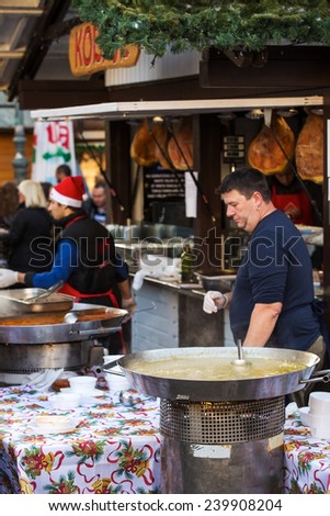 ZAGREB, CROATIA - DECEMBER 24, 2014: Cook and customers on the food stand with cooled fish, in Zagreb city center, during Christmas festivities and celebrations.