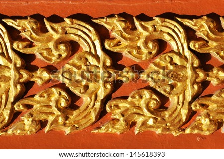 Gold ornaments on a building, fence or wall of the house. Handmade.