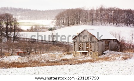 Early winter landscape old antique barn with hay and snow