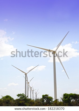 Wind turbine park showing several towers under a blue sky