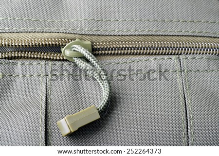 Close up shot of a zipper on a military bag pocket