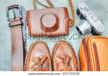 Several retro items of a photographer\'s gear on a gray concrete background