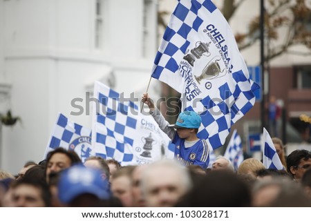 LONDON, MAY 20: Chelsea fans waving flags outside Stamford Bridge stadium to welcome back their team after historically winning the Champions League and The FA Cup in Chelsea, London, UK 20 May 2012.