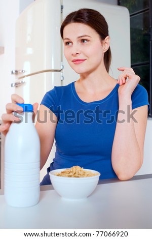 woman eating cereal with milk