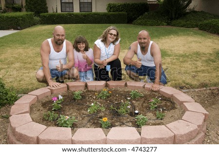 Happy Family in front of their first garden