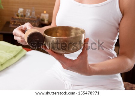 Hands holding singing bowl prepared for meditation