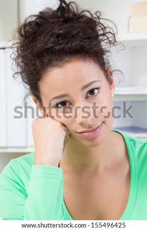 Portrait of sad young woman in office