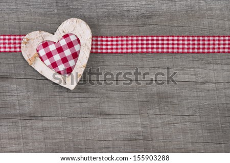 Top view of checked  heart decoration on wooden background for valentine, mother\'s day, wedding or birthday or just to say thank you