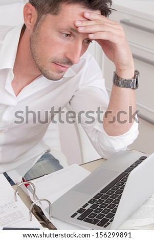 Stressed and frustrated business man reading in his laptop.