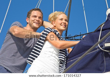 Young couple in love makes holiday on a sailboat