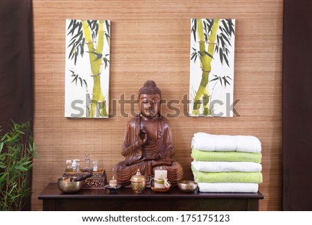 Asian decoration with buddha and candles in gold and brown in thai massage.