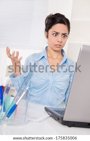 Shocked asian business woman has computer problems