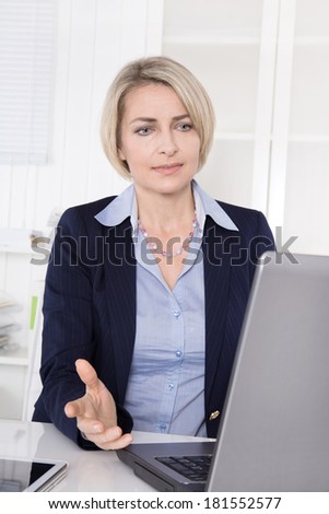 Woman at desk has problems with her computer.