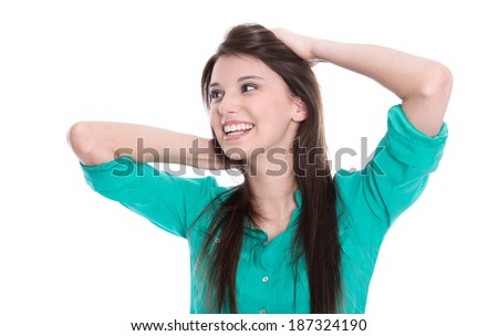 Happy young girl looking at the side in green blouse isolated on white.