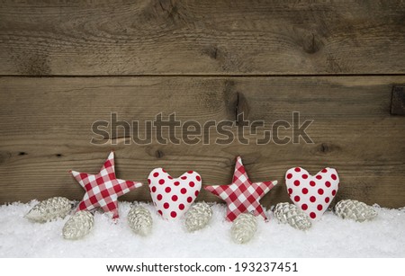 Wooden christmas background with red white checked hearts and stars.