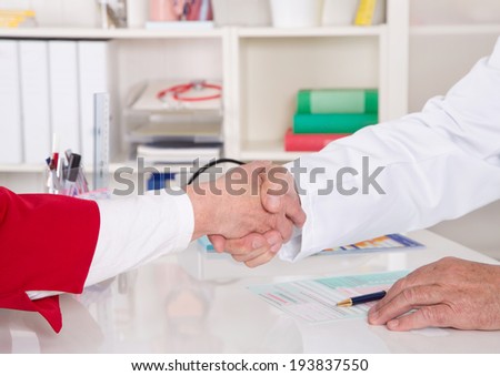 Handshake: doctor says welcome to his senior patient.
