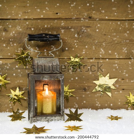 Christmas mood: old rustic lantern on a snowy background.