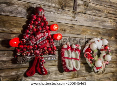 Christmas decoration country style: red, white things on wooden background.