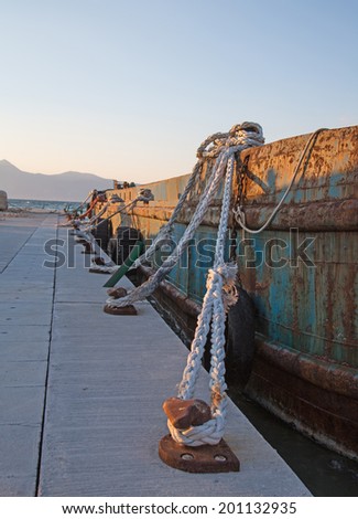 Old sisal ropes on a old rustic cargo boat in the port.