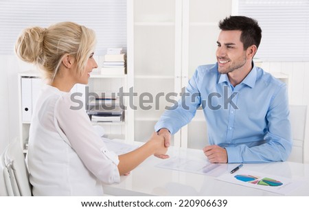 Handshake: Adviser says hello to his female customer.