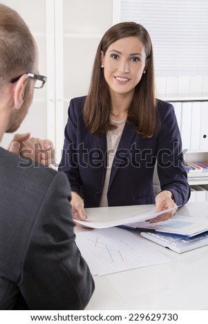 Customer and agent sitting at desk in a meeting or successful collaboration under man and woman in the office.