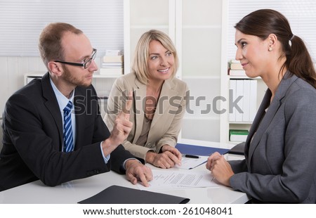 Career and candidate: three people sitting in a job interview for a management position.