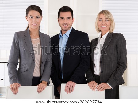 Portrait of three business people: man and woman in a team.