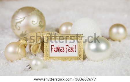 Merry christmas greeting card with german text and white, golden and silver decoration.