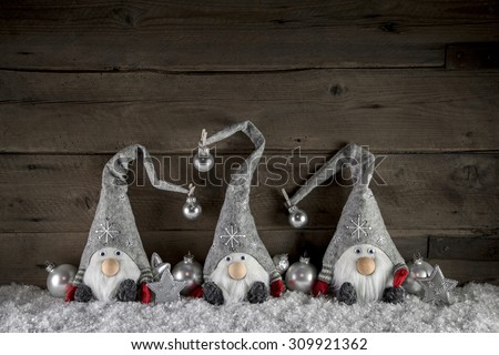 Rustic christmas decoration in country style with gnome-like santa on old wooden background.