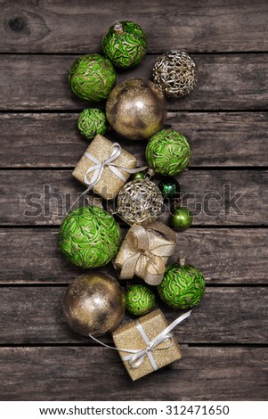 Apple green christmas presents with a red white check ribbon on old wooden bard for decoration.