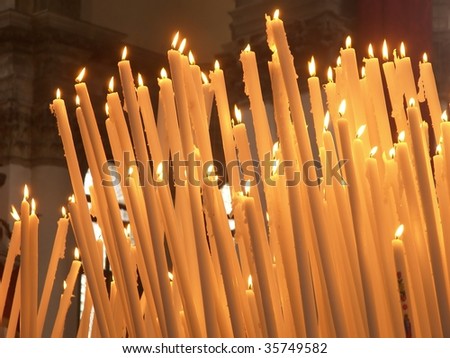 Burning candles in cathedral in Venice