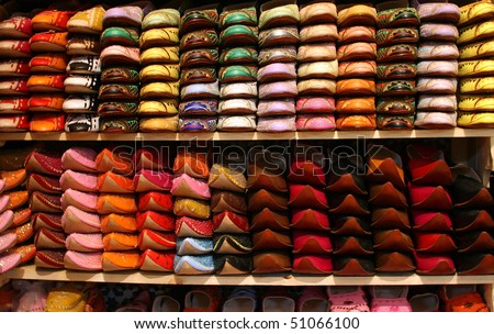 Moroccan slippers lined up on a shoe rack in a shop