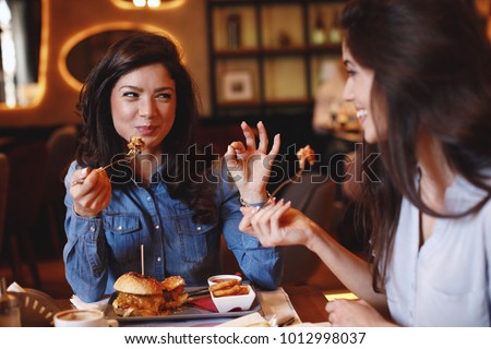 Similar – Image, Stock Photo Woman having lunch and browsing smartphone at home