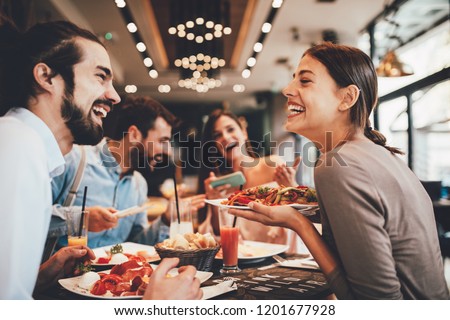 Group of Happy friends having breakfast in the restaurant ストックフォト © 