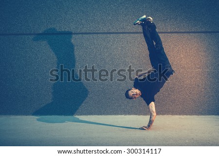 Similar – Image, Stock Photo Man doing acrobatic in the beach. Moody weather and rain