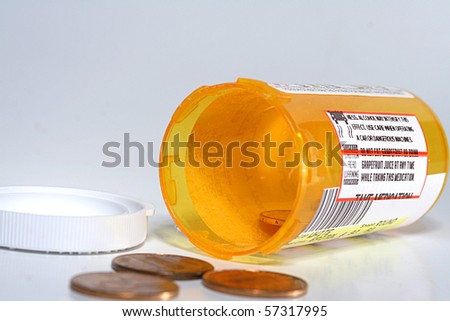 Empty medicine bottle with pennies.